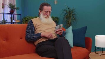 Rich happy man counting money cash and use calculator, calculate domestic income earnings at home video