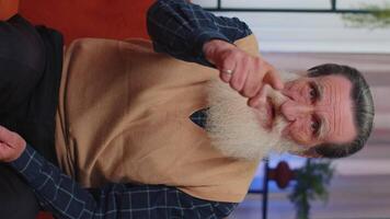 Senior elderly man smiling, pointing to camera, choosing lucky winner, indicating, inviting, approve video