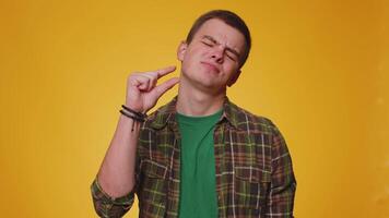 Man showing a little bit gesture with sceptic smile, showing minimum sign, measuring small size video