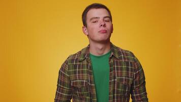Funny young man showing tongue making faces at camera, fooling around, joking, aping with silly face video