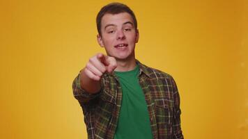 Man pointing to camera and looking with playful happy expression, making choice, showing direction video