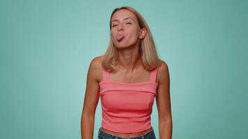Funny woman showing tongue making faces at camera, fooling around, joking, aping with silly face video