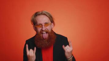 Overjoyed happy man showing rock n roll gesture by hands, cool sign, shouting yeah with crazy face video