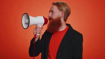 Smiling bearded man talking with megaphone, proclaiming news, loudly announcing sale advertisement video