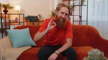 Happy cheerful bearded man looking approvingly at camera showing ok gesture, positive like sign video