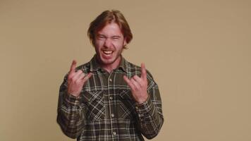Overjoyed happy man showing rock n roll gesture by hands, cool sign, shouting yeah with crazy face video