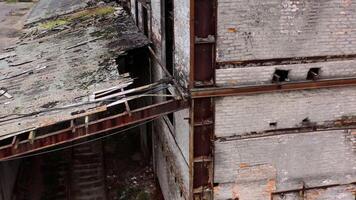 Ruined building. Old architecture with broken windows and many holes in the walls. Exterior of damaged enterprise during military action. Close-up. video