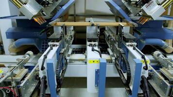 Robotic device for door production. Modern automated equipment making doors in a workshop. Front view. video