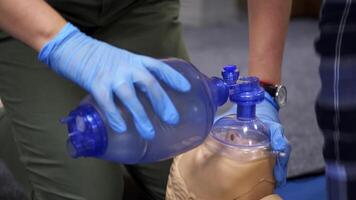 Cardiopulmonary resuscitation. Training demonstration of a chest compression and breathing on a dummy. Close-up. video