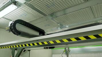 Robotic machine moving inside the plant. Automated device for door production in a modern workshop. video