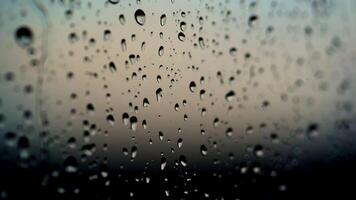 Rain drops on glass. Texture of rain drops on black background. Water droplets on glass. Rain drops on the a window pane after the rain. Close-up. video