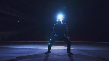 Senior man in costume on stage in darkness. Active man in hat dancing on stage during the performance video