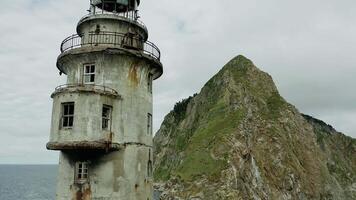 Weathered lighthouse near rocky island cliffs video