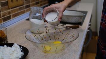The process of making a delicious treat or dessert. Ingredients for baking on the table. Top plan for chef cook. Home cooking with care for relatives. pouring sugar in a bowl of eggs video