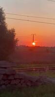 Stunning train journey capturing mesmerizing sunset over open fields and railway lines video