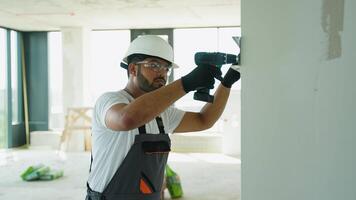 Indian Builder Installing Drywall with Power Drill on Site video
