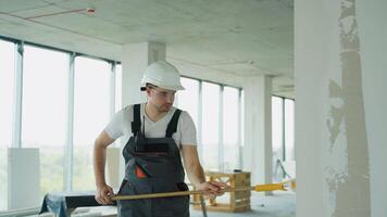 Builder Applying Wall Finish with Roller at Construction Site video