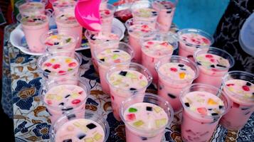Fruit ice in plastic cups ready to be distributed at school activities photo