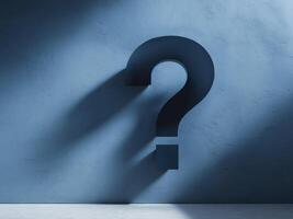 Textured blue wall with a shadowed large question mark symbol. photo