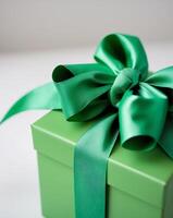 a close up of a green gift box with a green bow photo
