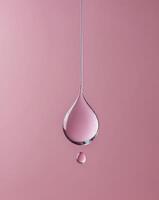 A pink background with a drop of water hanging from the ceiling photo