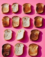 Different stages of toasted bread displayed on a pink background with vibrant colors and distinct textures photo