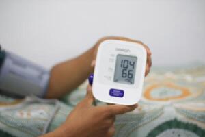 Lampung Selatan, september 13, 2024, Blood pressure monitoring with digital device photo