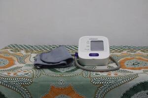 Lampung Selatan, september 13, 2024, Blood pressure monitoring device on patterned surface photo