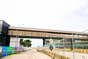 Bakauheni, January 17, 2025, Elevated pedestrian walkway with black metal framework and golden design photo