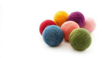 Various wool balls in vibrant colors on white background, copy space photo