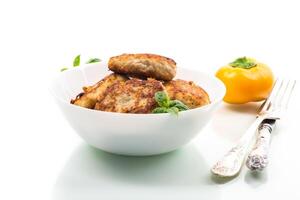 Nutritious dinner. fried chicken cutlets in a bowl, isolated on white background photo