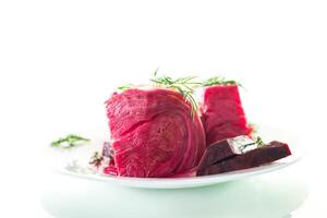 Vegetarian food. pickled cabbage with beets and carrots, in a plate, isolated on white background photo