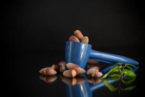 Tasty nuts. hazelnuts with nutcracker isolated on black background photo