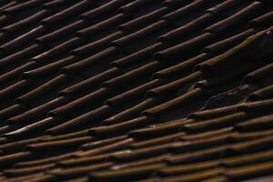 A close up of a roof with many different tiled roofs photo