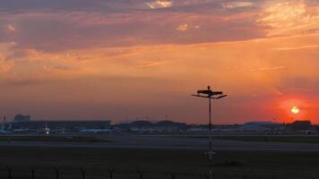 Cinematic footage of incredible golden sunset over airport airfield. Panoramic view of the terminal, apron and runway video