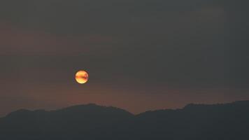 Abstract landscape of mountains with setting sun photo