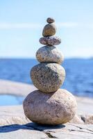 Pyramid of stones. Unstable balance of stone objects. photo