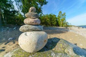 Man-made pyramid of stones. Unstable balance of objects. photo