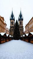 A picturesque Christmas scene in Pragues Old Town Square with a towering Christmas tree Gothic spires and wooden stalls selling mulled wine and festive treats photo
