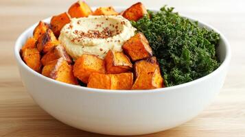 Healthy Food Revolution, Vegan Buddha bowl with roasted sweet potatoes, kale, and hummus photo