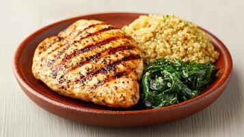Healthy Food Revolution, Quinoa, chicken breast, and spinach, lightly drizzled with olive oil photo
