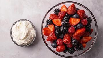 HHealthy Food Revolution, Fresh berry medley, with a side of whipped coconut cream. photo