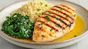 Healthy Food Revolution, Grilled chicken, quinoa, and sauteed spinach with a touch of olive oil photo