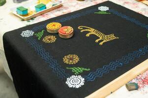 Colorful block print on fabric with floral and animal patterns photo