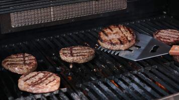 Commercial Style Super Slow Motion Footage with an Anonymous Chef Flipping Burger Meat on a Flame Grill. Close Up of a Tasty Beef Patty is Being Cooked in a Restaurant video