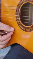 Man Tunes Guitar With Tuning Fork For Notes video
