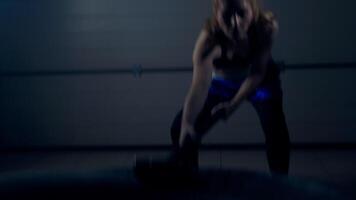 Close-up of a crossfit exercise, hammer blows on a tire after which dust and chalk fly around video