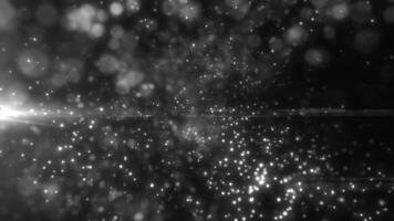 Abstract bokeh effect with white light particles on a black background, resembling floating stars in a cosmic void video