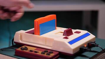 Hand inserting cartridge into retro game console video