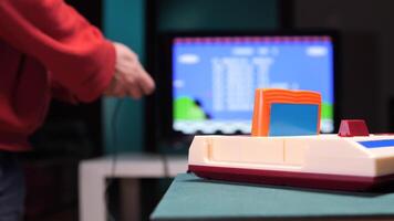 Boy playing with a retro game console holding a joystick. Start play game video